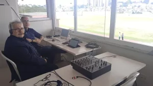 Dois homens narrando a corrida em cadeira de rodas